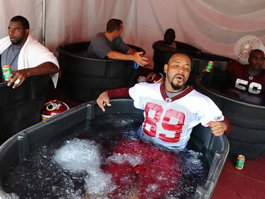 Athlete using inflatable ice bath tub after workout